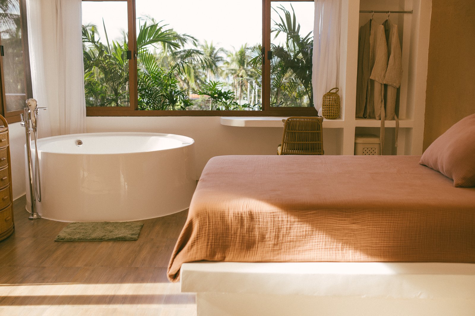 Palm Villa bedroom with soaking tub in soft jungle light